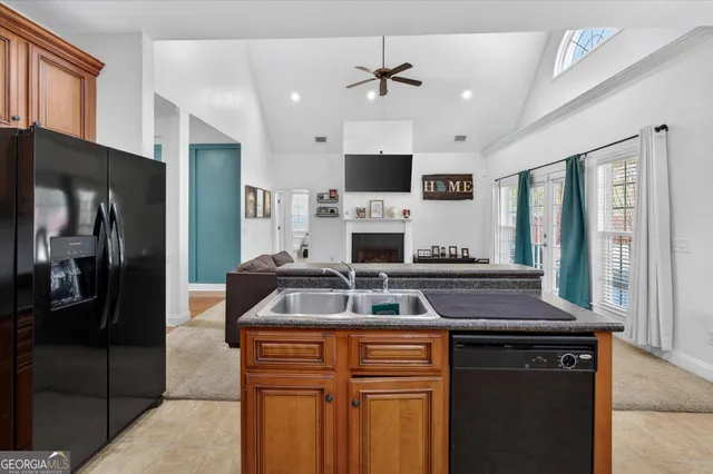 a kitchen with stainless steel appliances granite countertop a stove a sink and a refrigerator