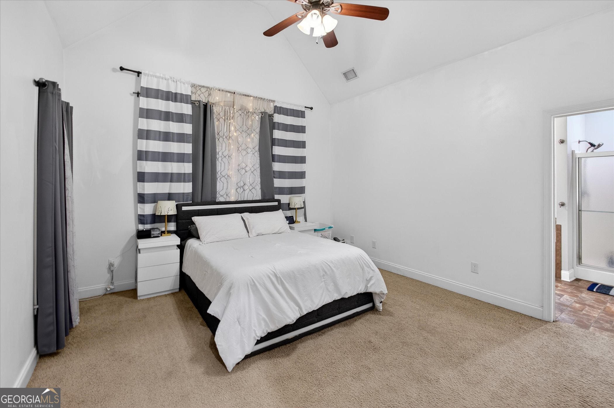 1600 Colony Lane Brooklet, GA 30415 - Photo 24 of 44 a spacious bedroom with a bed and a chandelier