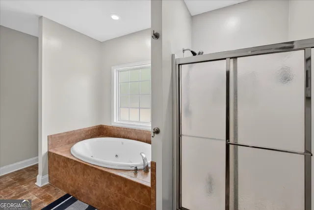 a bathroom with a tub and a shower