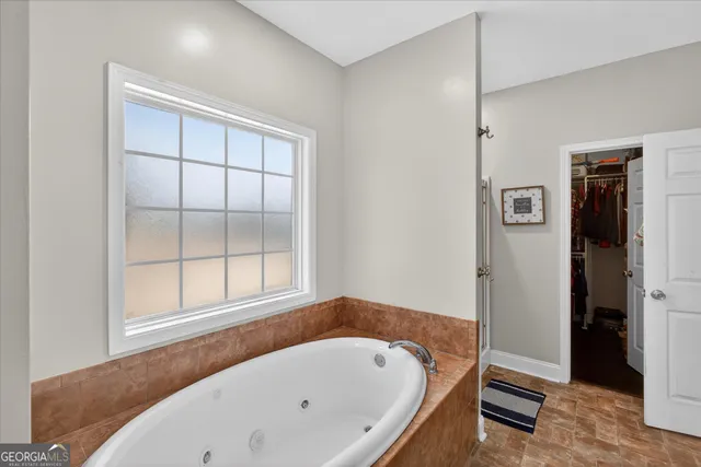a bathroom with a bathtub and a window