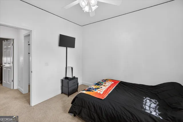 a bedroom with a bed and a lamp on table