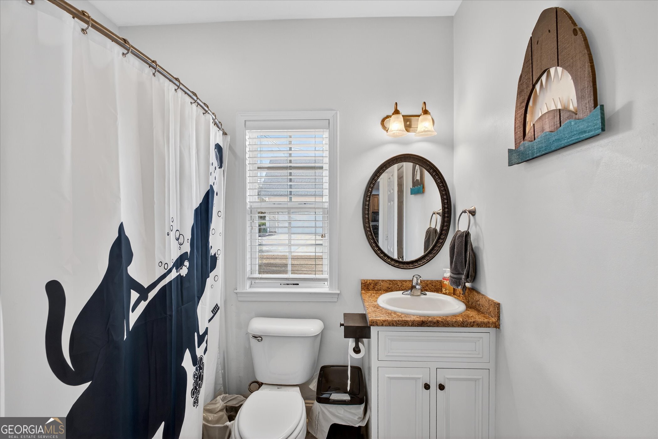 1600 Colony Lane Brooklet, GA 30415 - Photo 34 of 44 a bathroom with a toilet a sink and a mirror