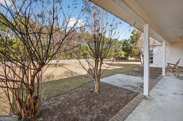 a view of a backyard with large trees