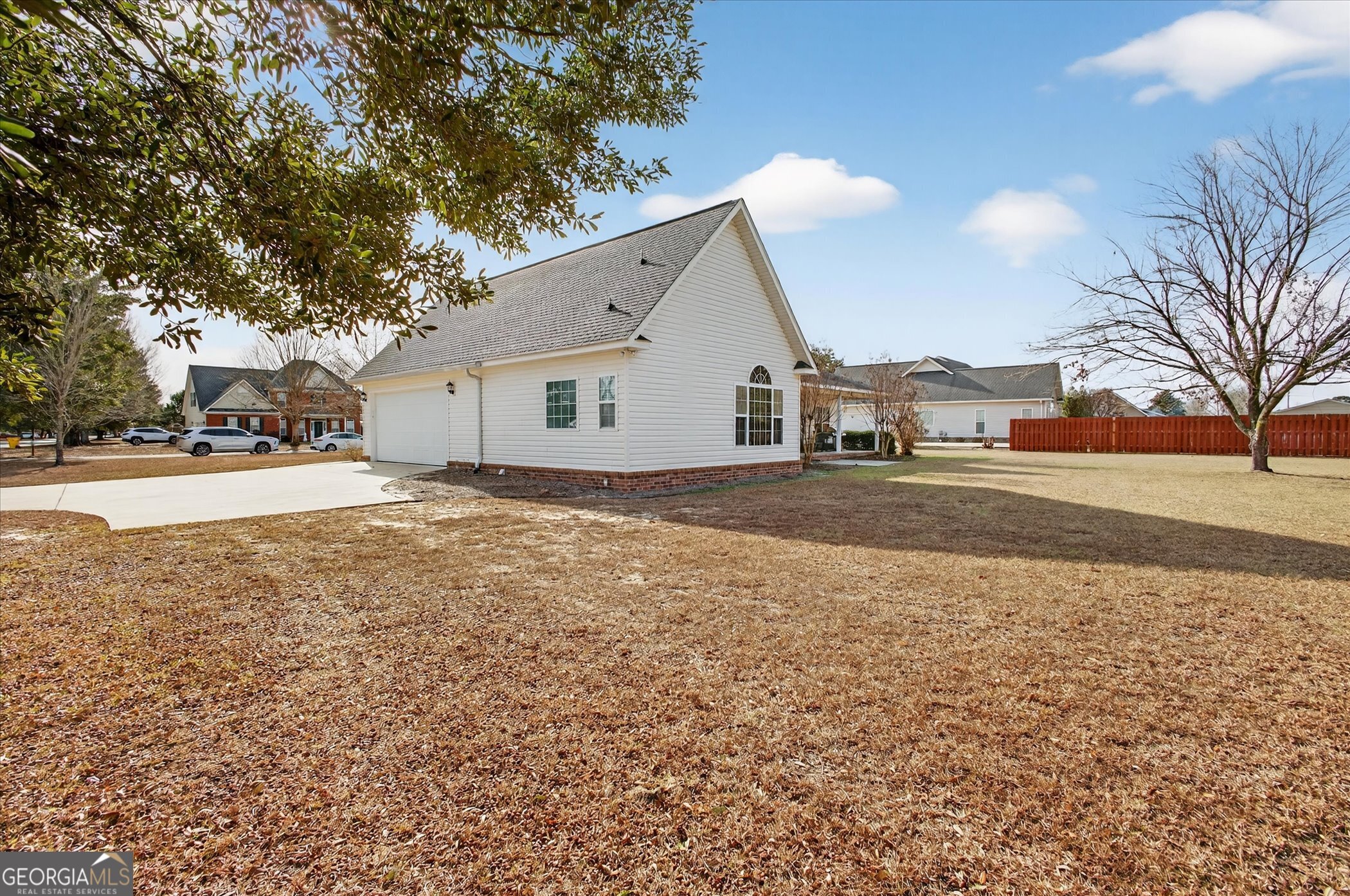 1600 Colony Lane Brooklet, GA 30415 - Photo 43 of 44 a backyard of a house with large trees and a parked car