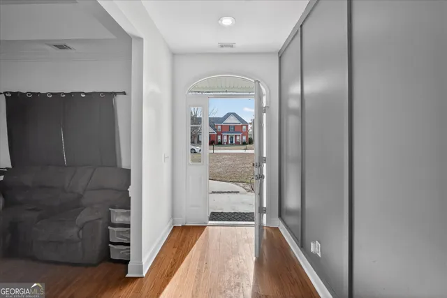 view of a hallway view with wooden floor and staircase