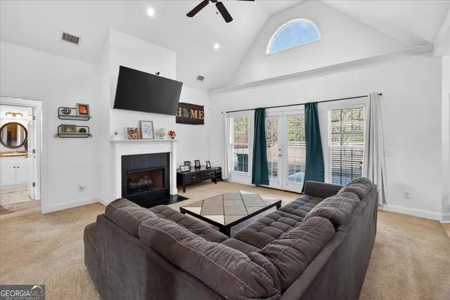 a living room with furniture fireplace and flat screen tv