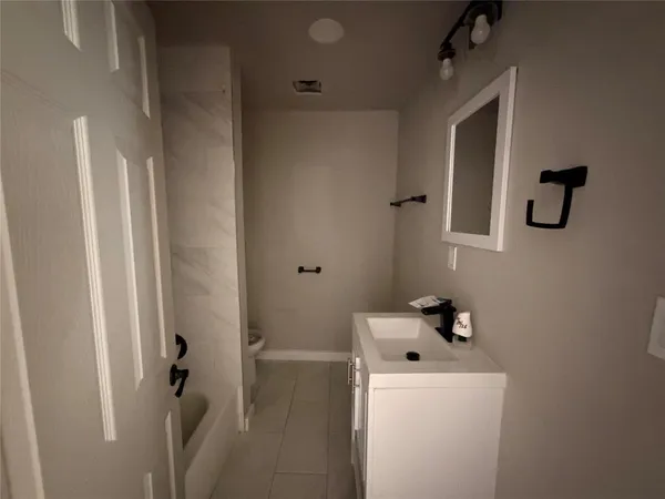 a bathroom with a tub and sink