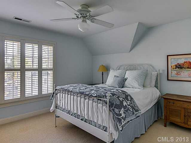 1440 Andover Road Charlotte, NC 28211 - Photo 14 of 16 a bedroom with a large bed and a chandelier