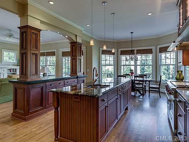1440 Andover Road Charlotte, NC 28211 - Photo 5 of 16 a kitchen with stainless steel appliances granite countertop sink stove and wooden floor