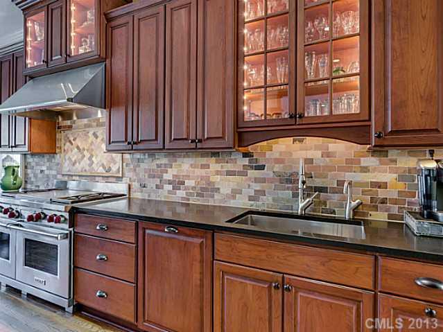 1440 Andover Road Charlotte, NC 28211 - Photo 7 of 16 a kitchen with stainless steel appliances granite countertop a sink a stove and cabinets