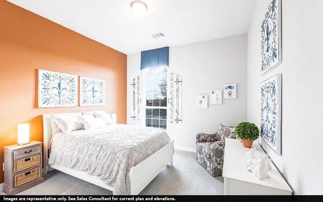 a bedroom with a bed mirror and window