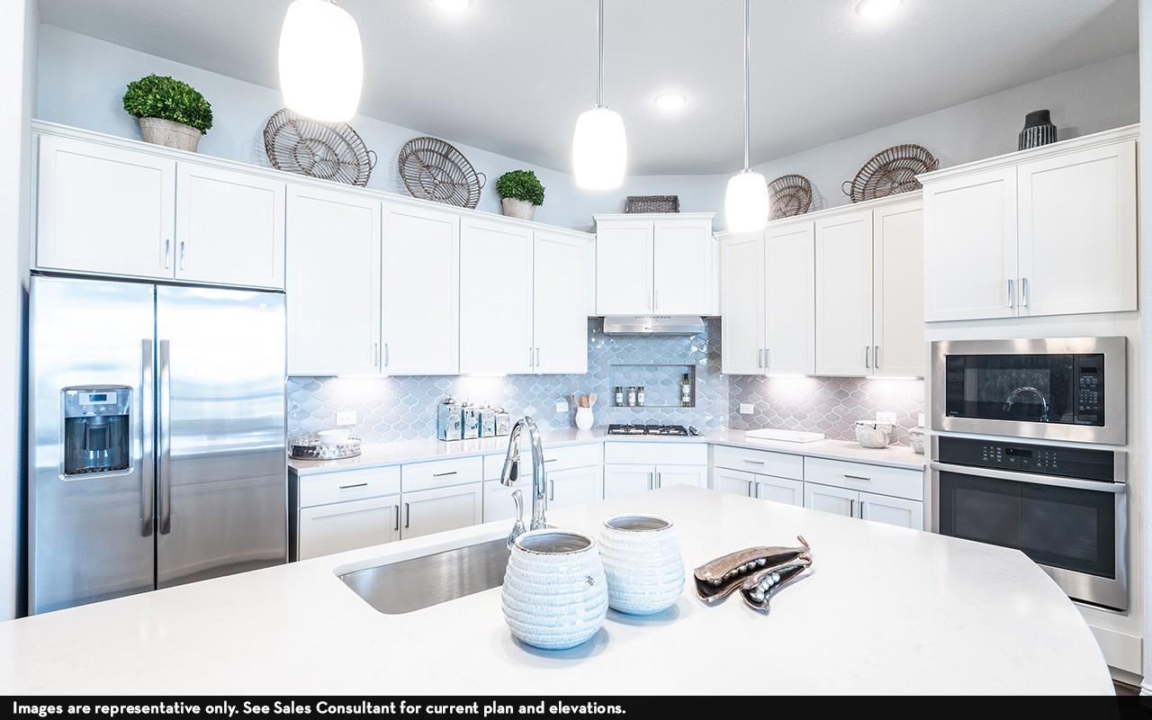 1051 Lakeland Circle Rosharon, TX 77583 - Photo 7 of 19 a kitchen with stainless steel appliances kitchen island granite countertop a sink refrigerator and cabinets