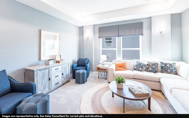 a bedroom with furniture and a large window