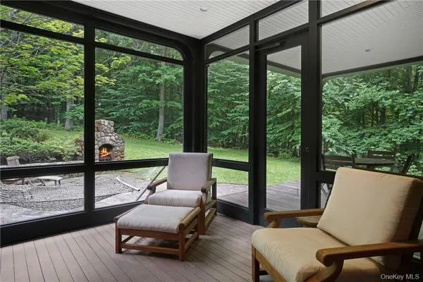 a living room with furniture and a floor to ceiling window