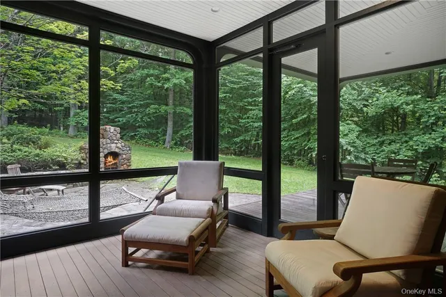 a living room with furniture and a floor to ceiling window