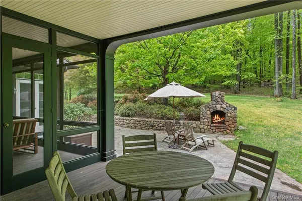 a backyard of a house with table and chairs