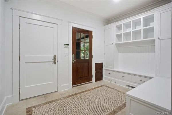 a view of an empty room with wooden floor and cabinet