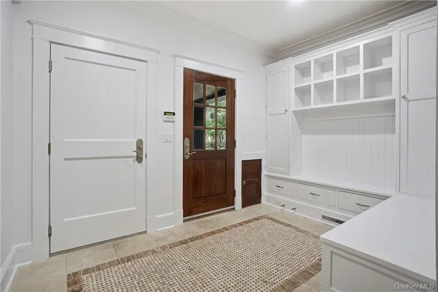 a view of an empty room with wooden floor and cabinet
