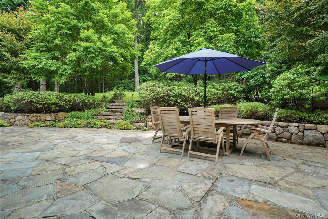 8 Brady Road Bedford Corners, NY 10549 - Photo 2 of 30 a view of a tables and chairs under an umbrella in backyard