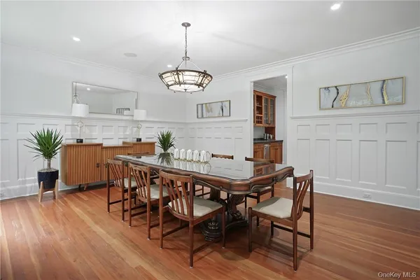 a view of a dining room with furniture wooden floor and chandelier