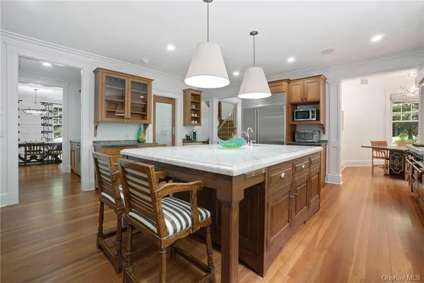 a kitchen with a table chairs refrigerator and cabinets