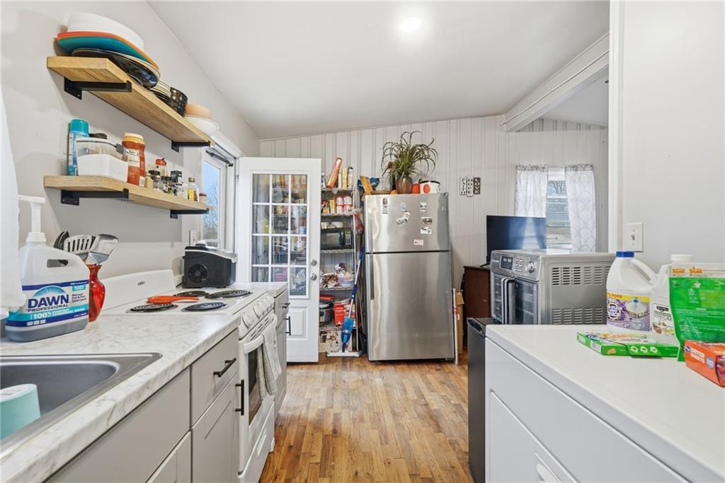 502 Old Canton Road Ball Ground, GA 30107 - Photo 24 of 29 a kitchen with a refrigerator and a sink