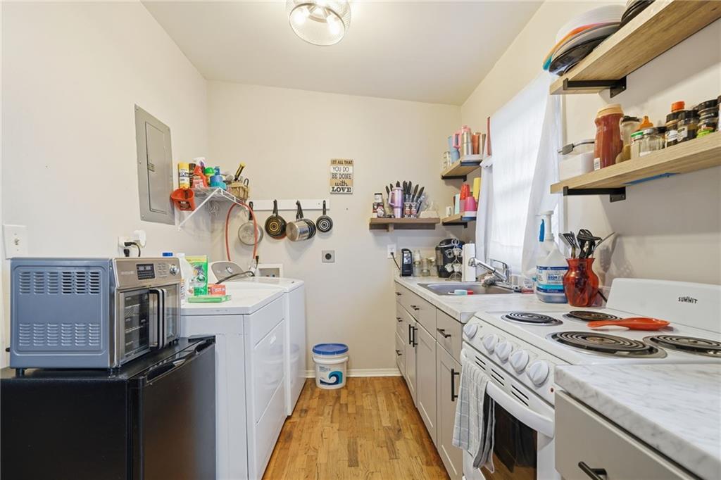 502 Old Canton Road Ball Ground, GA 30107 - Photo 25 of 29 a kitchen with a sink appliances and cabinets