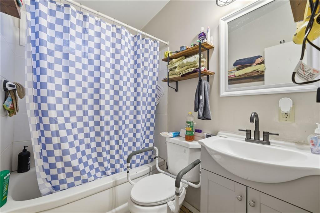 502 Old Canton Road Ball Ground, GA 30107 - Photo 27 of 29 a bathroom with a sink toilet and mirror