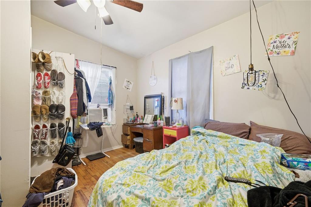 502 Old Canton Road Ball Ground, GA 30107 - Photo 28 of 29 a bedroom with a bed and a chandelier