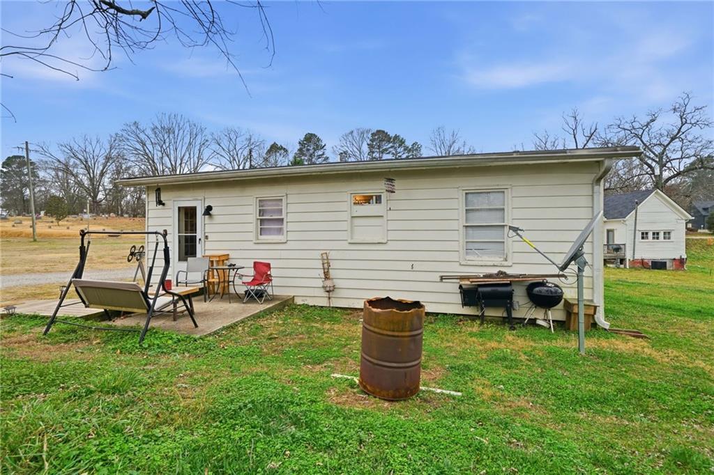 502 Old Canton Road Ball Ground, GA 30107 - Photo 5 of 29 a view of a backyard with table and chairs