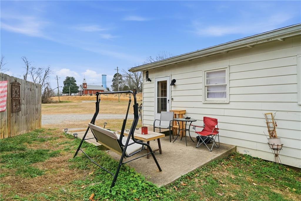 502 Old Canton Road Ball Ground, GA 30107 - Photo 6 of 29 a view of a chairs and tables in the back yard of the house