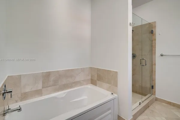 a bathroom with a tub and shower