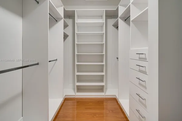a view of walk in closet with empty racks