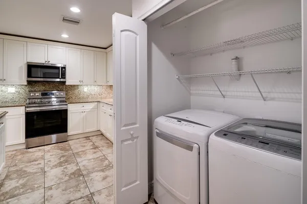 a kitchen with a stove and a refrigerator