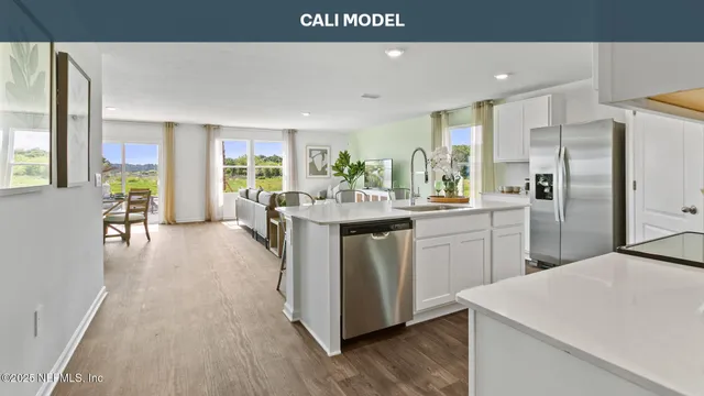 a large kitchen with stainless steel appliances granite countertop a sink and a stove