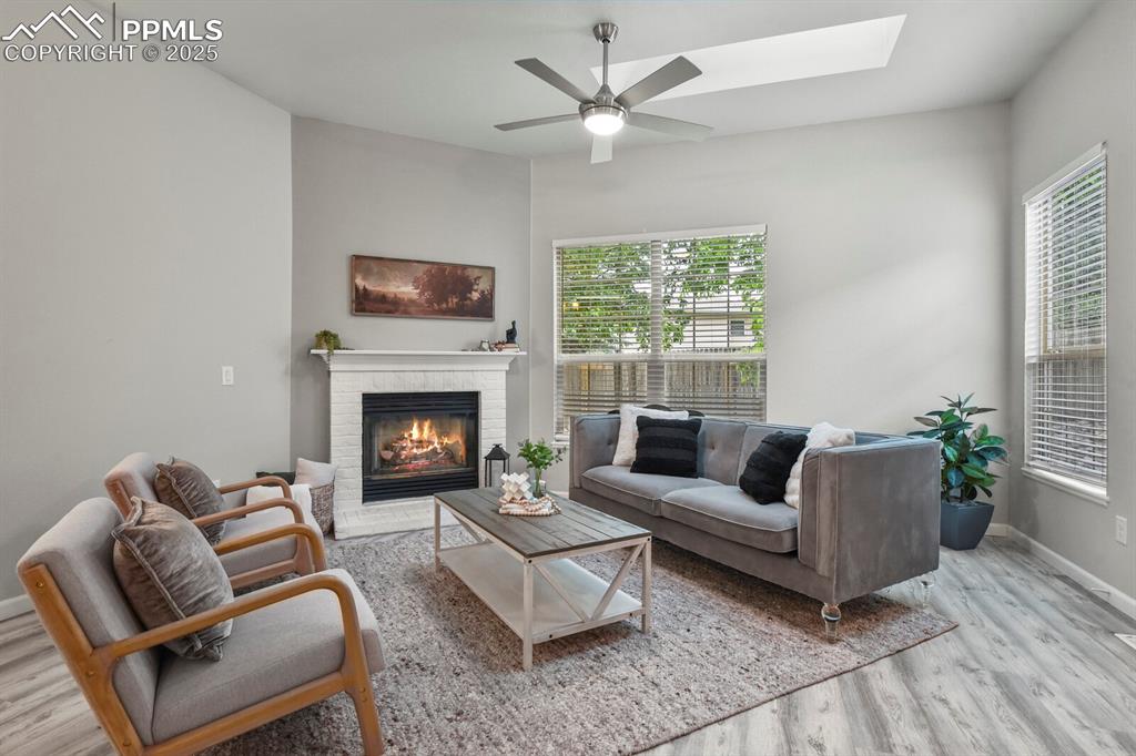 6868 Los Reyes Circle Colorado Springs, CO 80918 - Photo 4 of 47 a living room with furniture and a fireplace