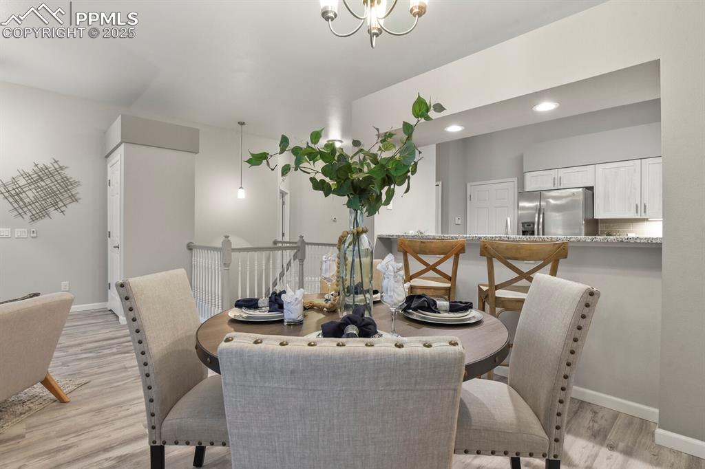 6868 Los Reyes Circle Colorado Springs, CO 80918 - Photo 10 of 47 a dining room with furniture and potted plant