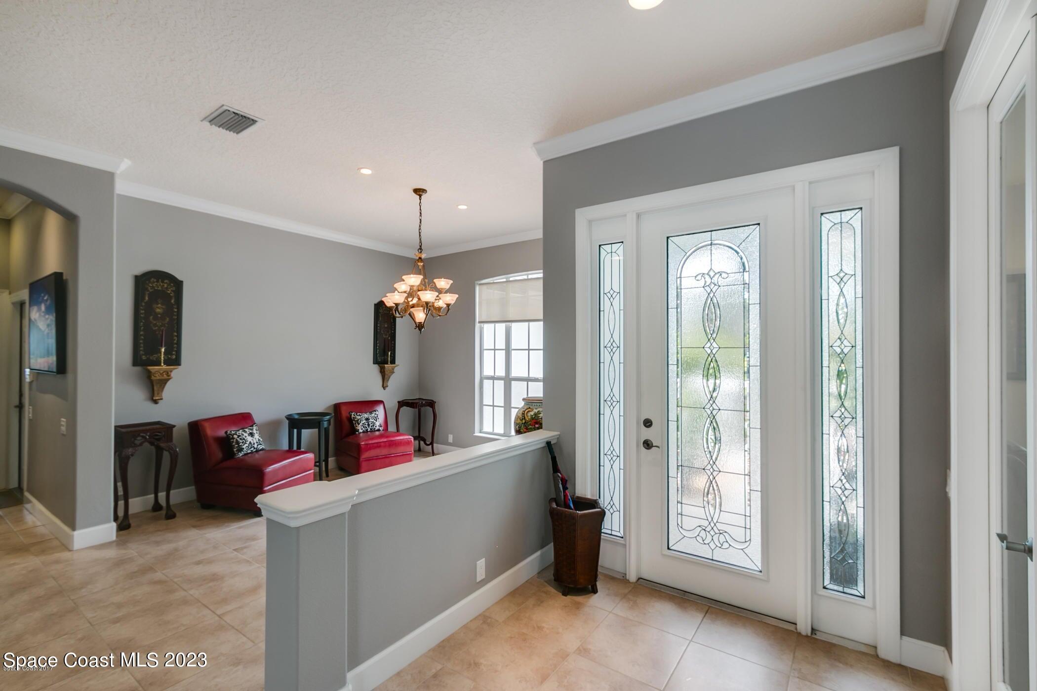 1840 Winding Ridge Circle Southeast Palm Bay, FL 32909 - Photo 11 of 41 a living room with furniture and a flat screen tv