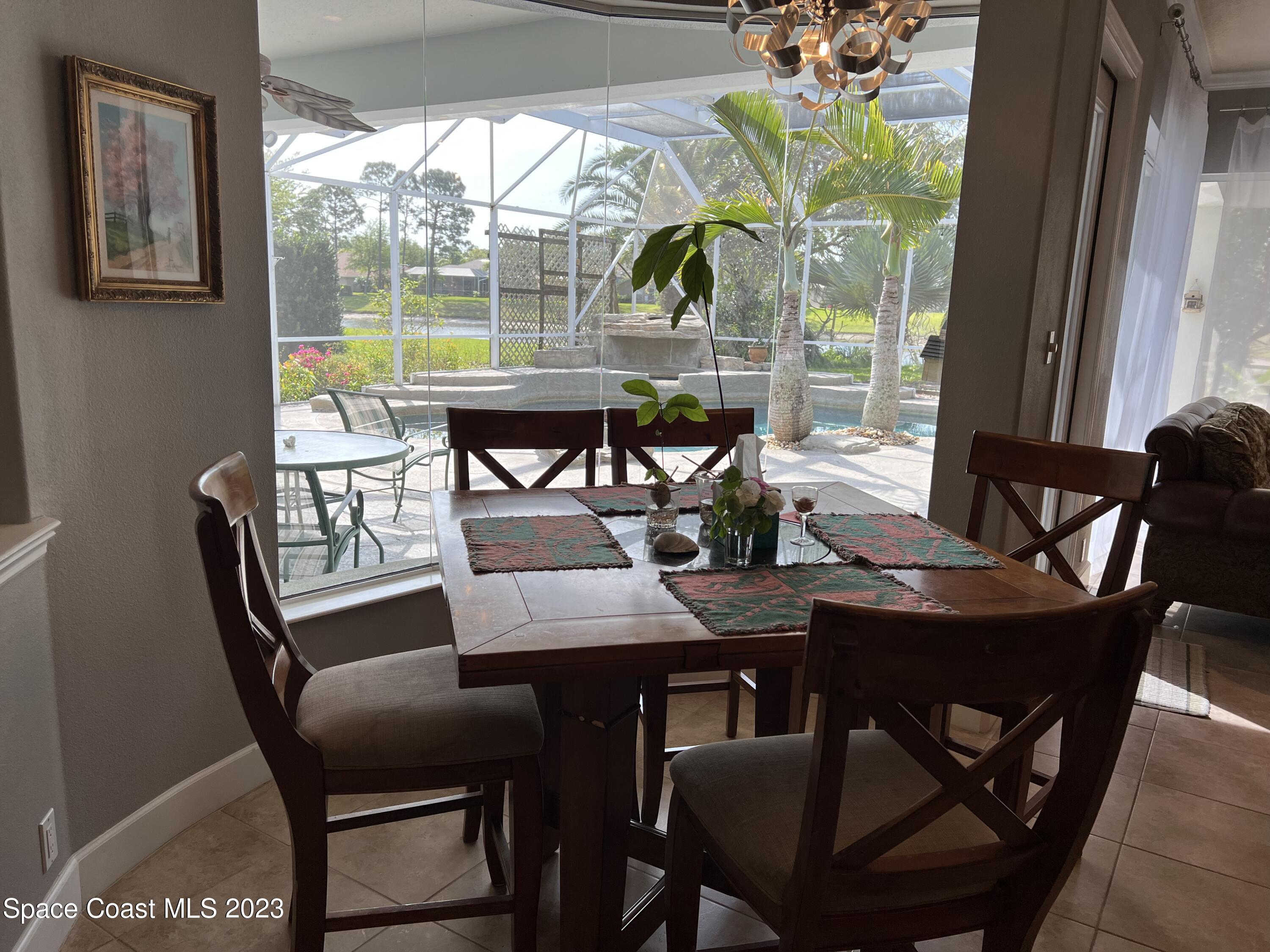 1840 Winding Ridge Circle Southeast Palm Bay, FL 32909 - Photo 17 of 41 a view of a dining room with furniture window and outside view