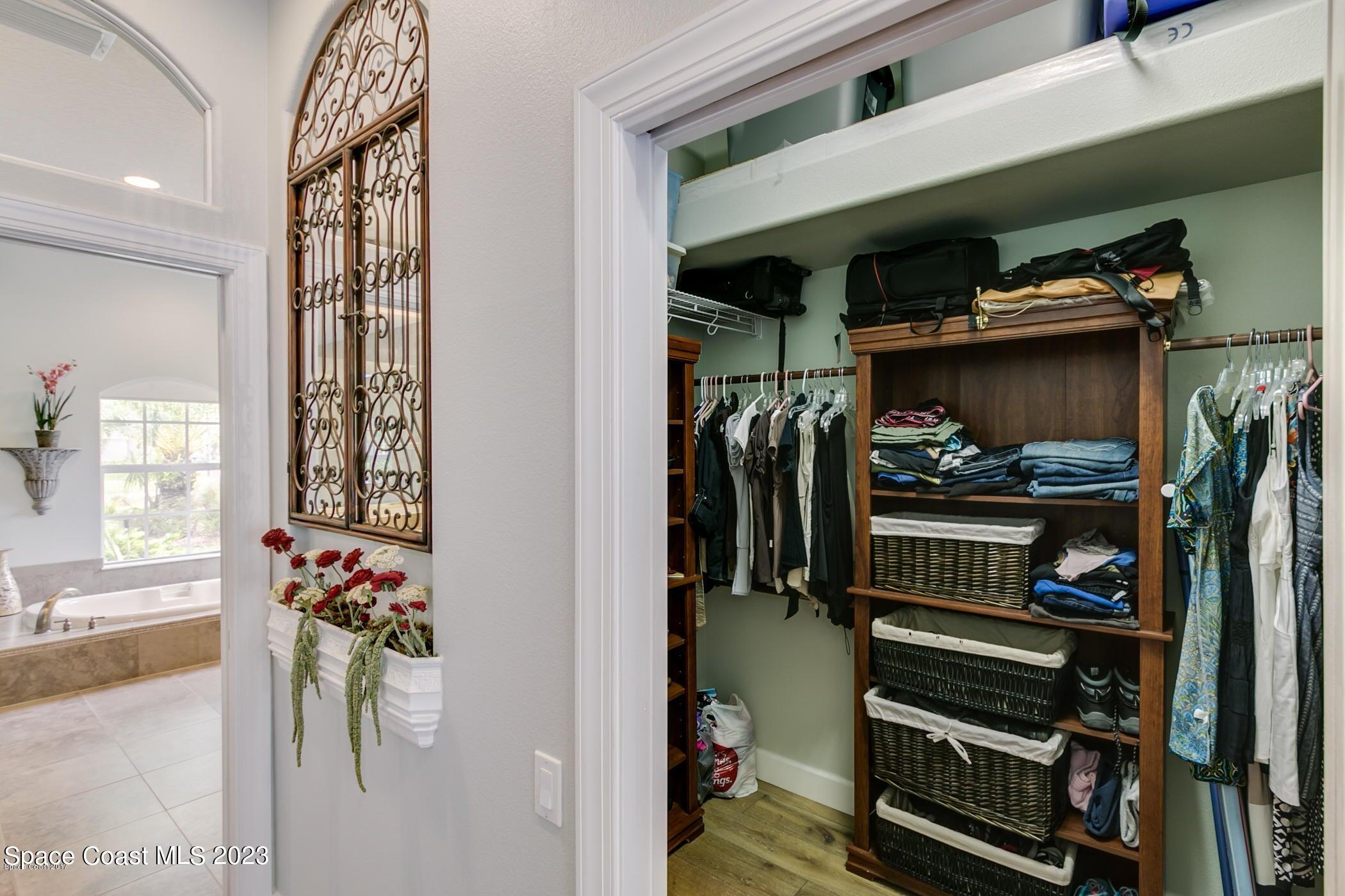 1840 Winding Ridge Circle Southeast Palm Bay, FL 32909 - Photo 24 of 41 a view of walk in closet with clothes and shoes