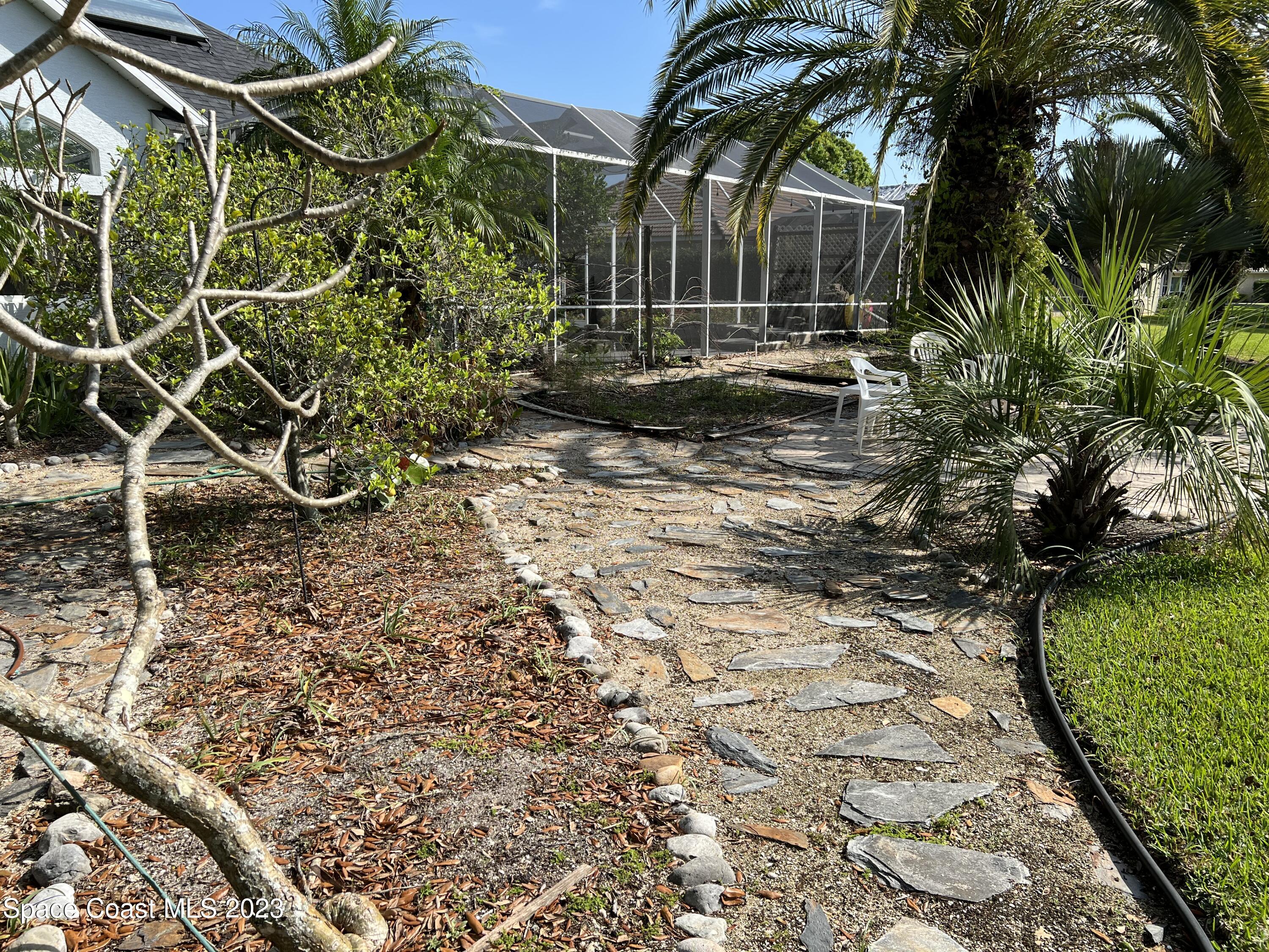 1840 Winding Ridge Circle Southeast Palm Bay, FL 32909 - Photo 32 of 41 a backyard of a house with lots of green space