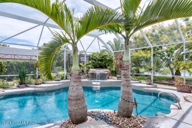 1840 Winding Ridge Circle Southeast Palm Bay, FL 32909 - Photo 40 of 41 a view of a swimming pool with a patio