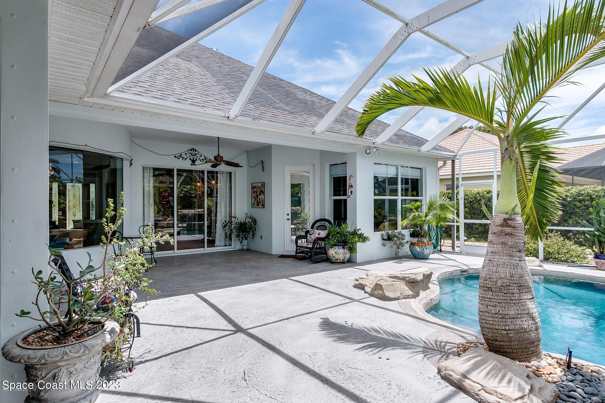 1840 Winding Ridge Circle Southeast Palm Bay, FL 32909 - Photo 4 of 41 a view of a house with backyard sitting area and porch