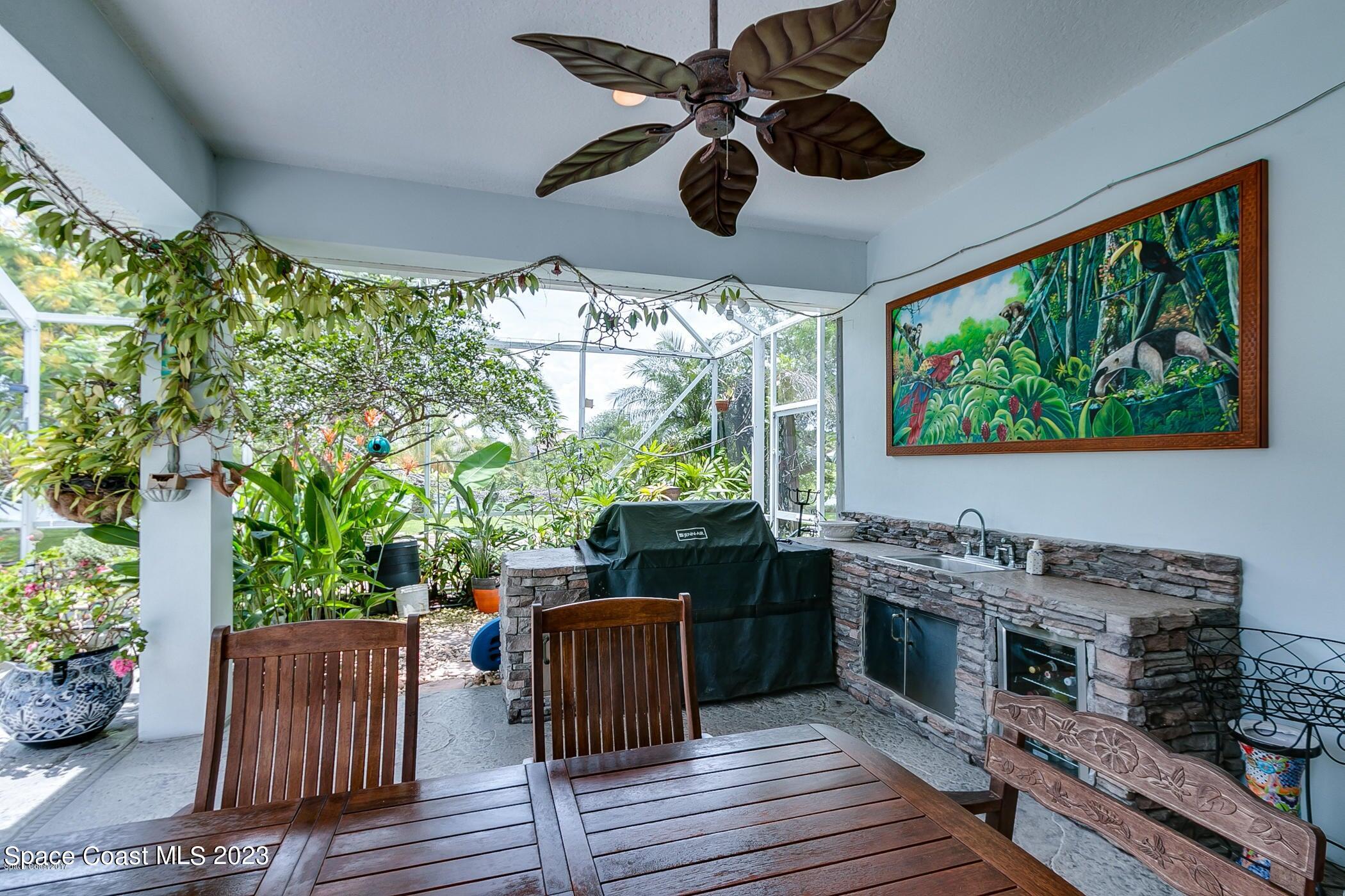 1840 Winding Ridge Circle Southeast Palm Bay, FL 32909 - Photo 6 of 41 a kitchen with stainless steel appliances granite countertop a stove and a wooden floors