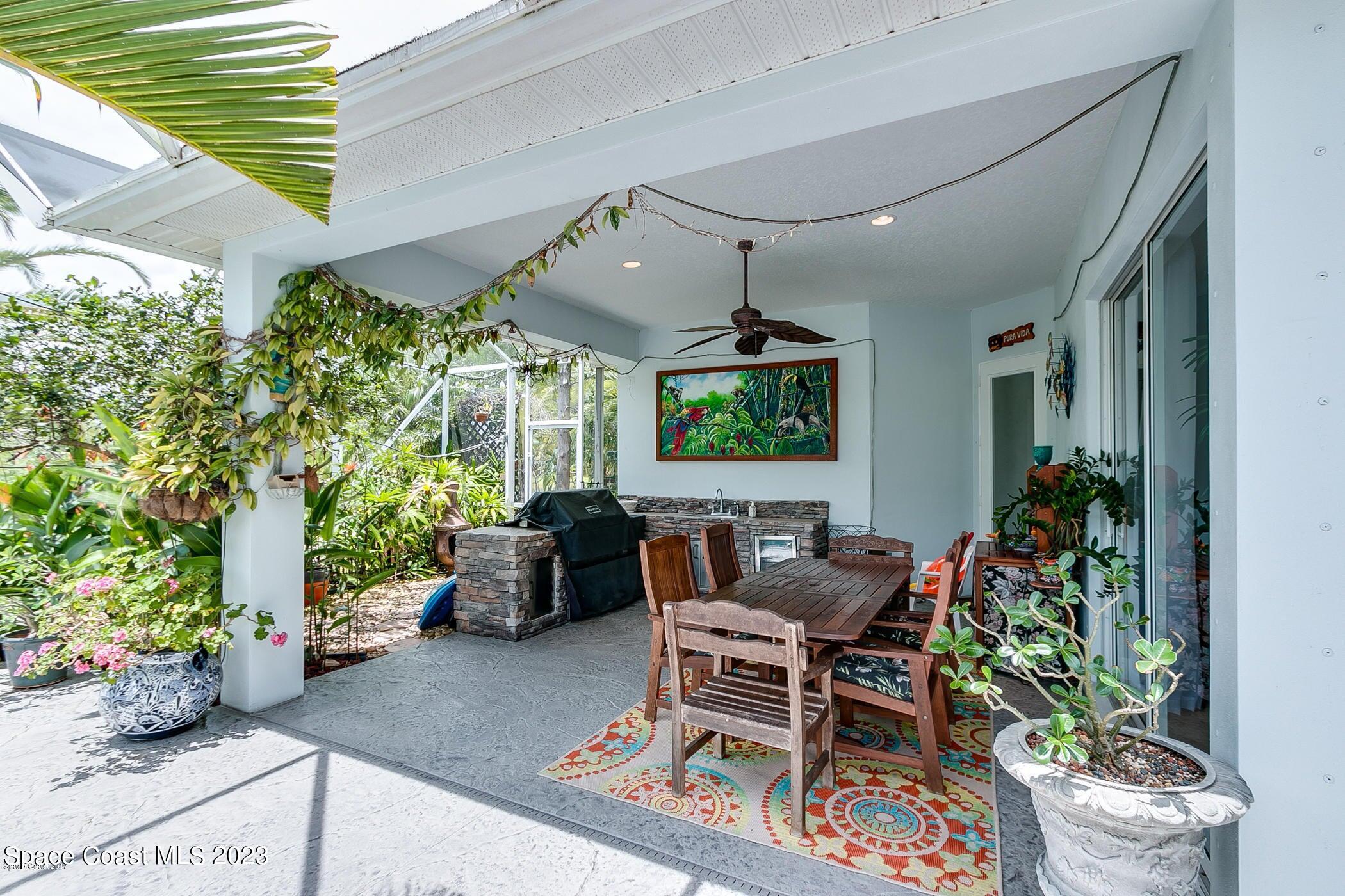 1840 Winding Ridge Circle Southeast Palm Bay, FL 32909 - Photo 7 of 41 a outdoor living space with furniture and potted plants