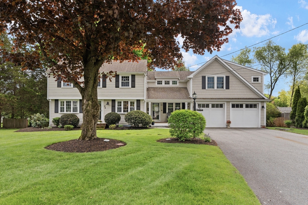 a front view of a house with a garden