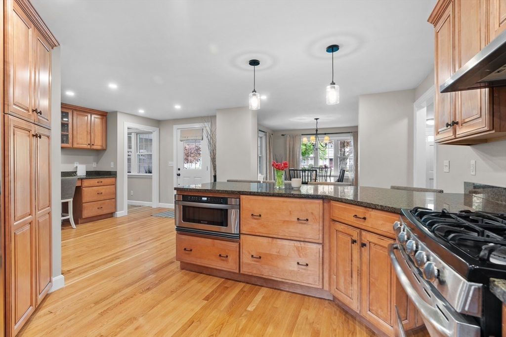 26 Cushing Road Westwood, MA 02090 - Photo 12 of 42 a kitchen with stainless steel appliances granite countertop a stove and a refrigerator