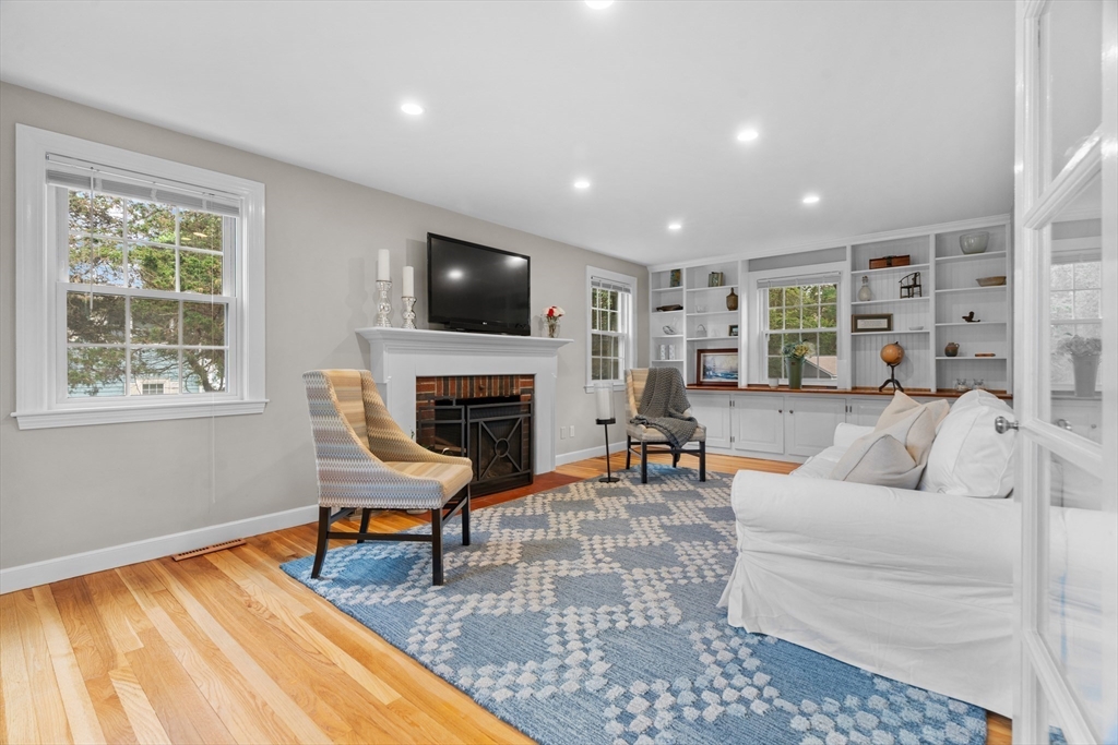 26 Cushing Road Westwood, MA 02090 - Photo 15 of 42 a living room with furniture a fireplace and a flat screen tv