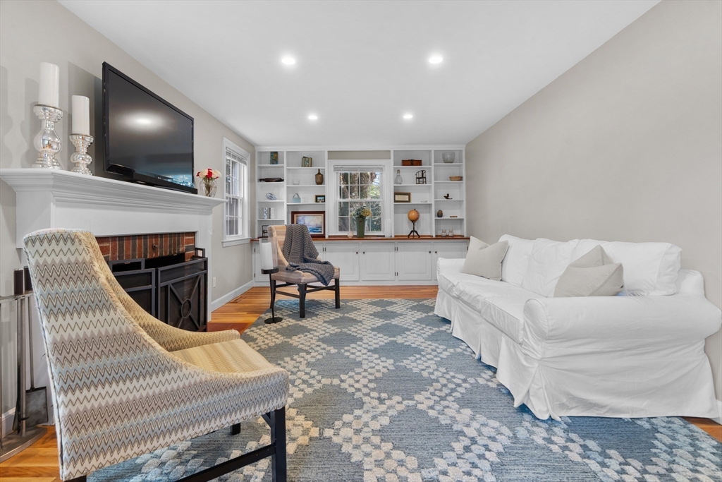 26 Cushing Road Westwood, MA 02090 - Photo 16 of 42 a living room with furniture a flat screen tv and a fireplace