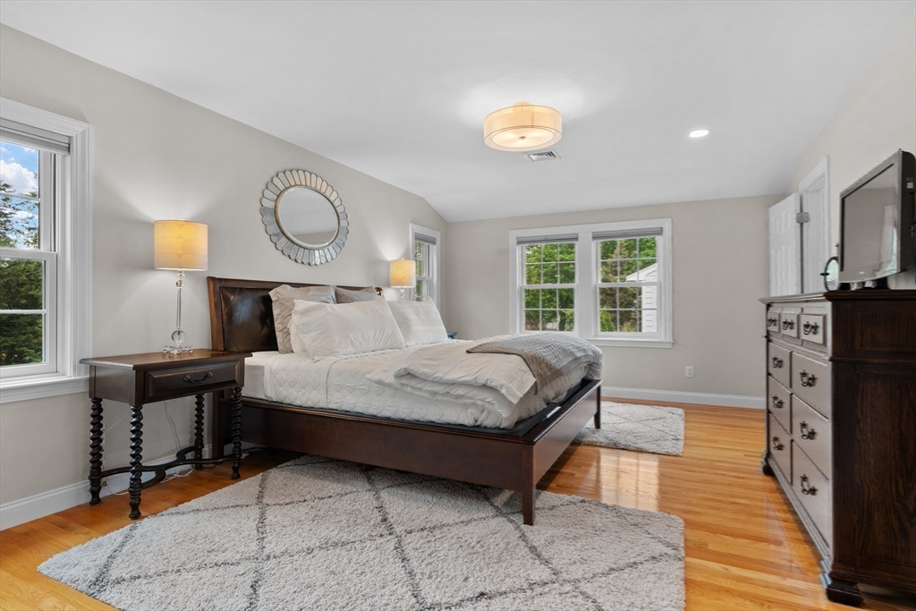 26 Cushing Road Westwood, MA 02090 - Photo 19 of 42 a bedroom with a bed and wooden floor